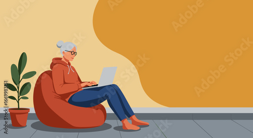 Relaxed senior woman in glasses sits on a bean bag, using a laptop at home. Modern lifestyle, comfortable remote work, or online learning.