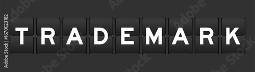 Black color analog flip board with word trademark on gray background