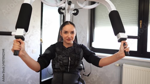 Woman exercising arms with ems suit