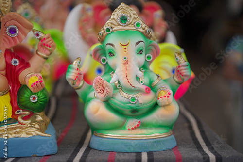 Photography Lord Ganesha idol for Ganesh Chaturthi festival in India, Colorful Ganpati statue Stock Photo, Lord Ganesha murti