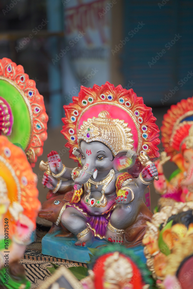 Fototapeta premium Lord Ganesha idol for Ganesh Chaturthi festival in India, Colorful Ganpati statue Stock Photo, Lord Ganesha murti. 
