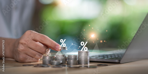 фотографія Concept of interest growth and financial investment strategy shown by a hand stacking coins with percentage icons and rising graph, interest, savings, profitability, and financial goal tracking