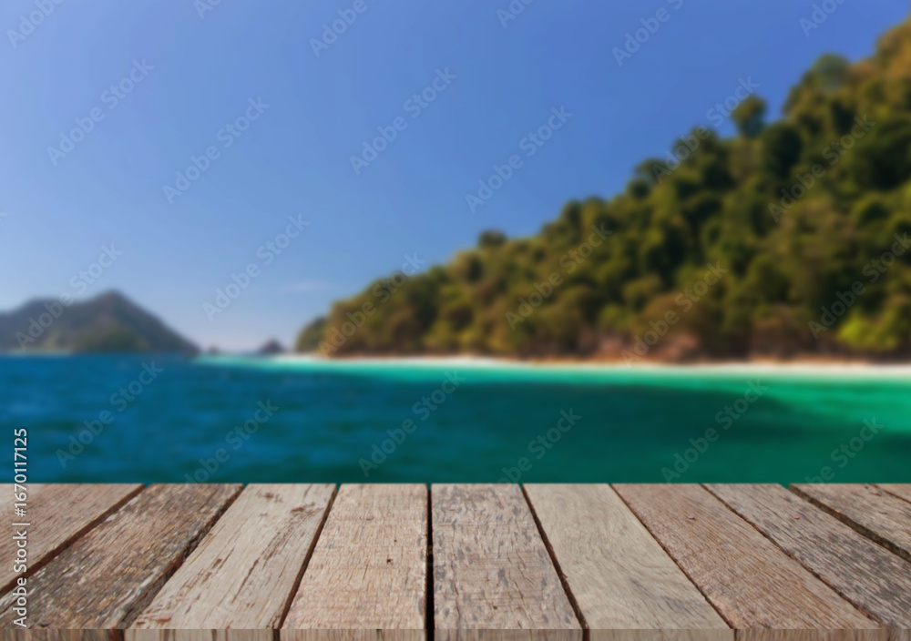 Fototapeta premium Wooden table top on the beach or sea.Party on the beach sunshine time concept.For montage product display or design key visual layout.View of copy space.