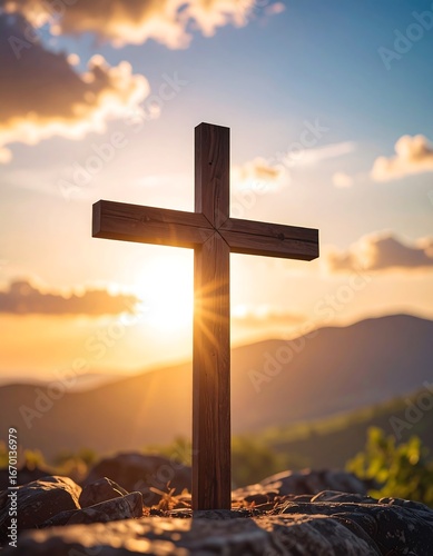Wooden cross at sunset over mountains