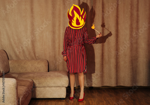 Woman in retro style standing in living room with fire head symbolizing burnout