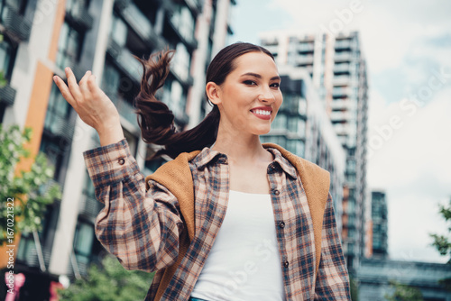 Young brunette woman enjoying outdoor urban city surroundings with a smile on a sunny day in casual trendy outfit Free Download Young brunette woman enjoying outdoor urban city surroundings with a smile on a sunny day in casual trendy outfit - GFXLoad