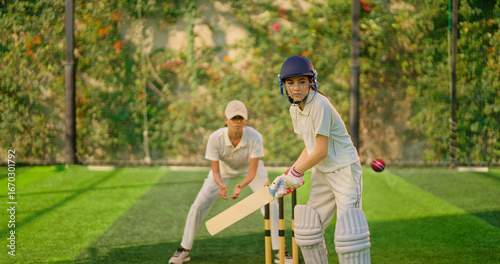 Indian gen z young adult athlete sports woman girl standing at outdoor match play ground wear gloves white uniform protective helmet Asian cricket player female lady hold bat hitting ball do practice