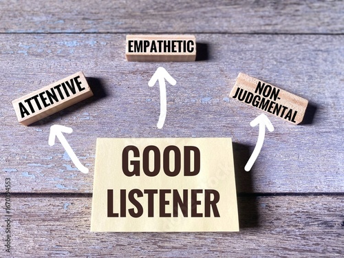 Qualities of a good listener include being attentive, non-judgmental, and empathetic written on wooden blocks and sticky notes.