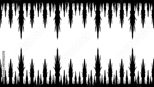 Abstract silhouette of ice stalactites hanging from above, a striking black and white visual capturing the unique formations in a natural cave. 