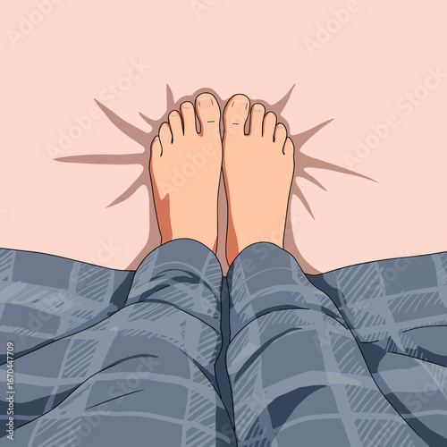 Bare feet of person relaxing under blanket on bed  