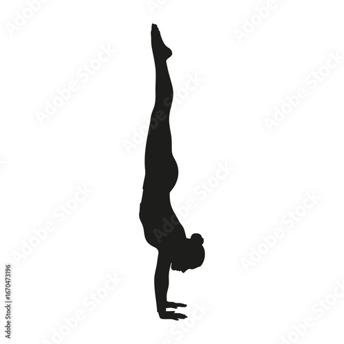 Silhouette of gymnast performing handstand exercise