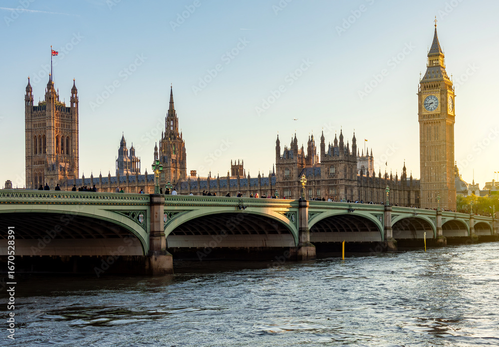 Naklejka premium Houses of Parliament with Big Ben tower and Westminster bridge at sunset, London, UK