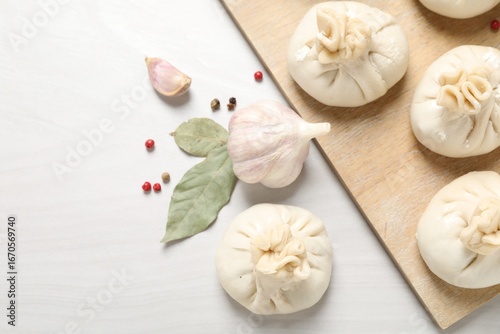 Wallpaper Mural Uncooked khinkalis (dumplings) and spices on white wooden table, flat lay. Space for text Torontodigital.ca