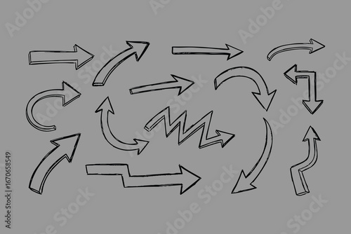 A collection of hand drawn arrows in various styles and directions sketched with a textured graphic effect on a solid gray background