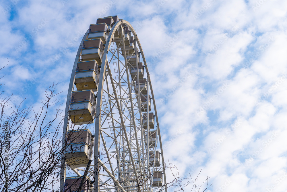 Fototapeta premium Ferris wheel with blue cloudy sky in the background in Hungary