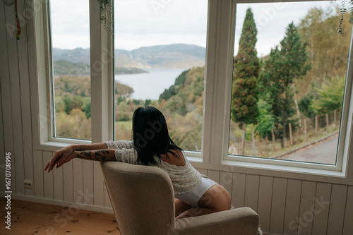 Woman enjoying a scenic view by the window Free Download Woman enjoying a scenic view by the window - GFXLoad