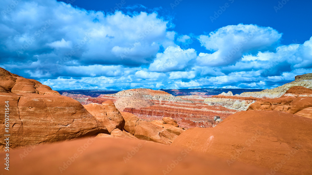 Fototapeta premium Red Sandstone Formations and Dramatic Clouds Paria Canyon Ground Level