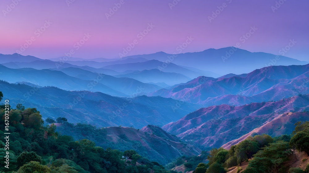 Obraz premium A vast vista of layered mountain ranges bathed in soft, twilight hues of purple and blue, showcasing a serene and tranquil mountain landscape.