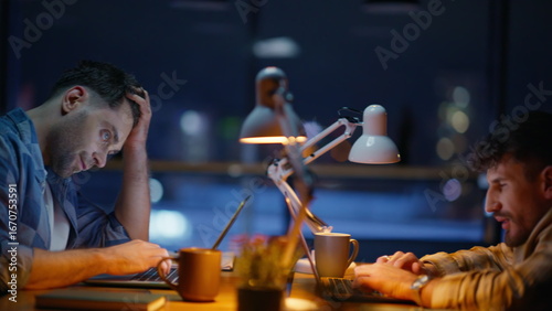 Fotografie Tired man labouring evening office closeup