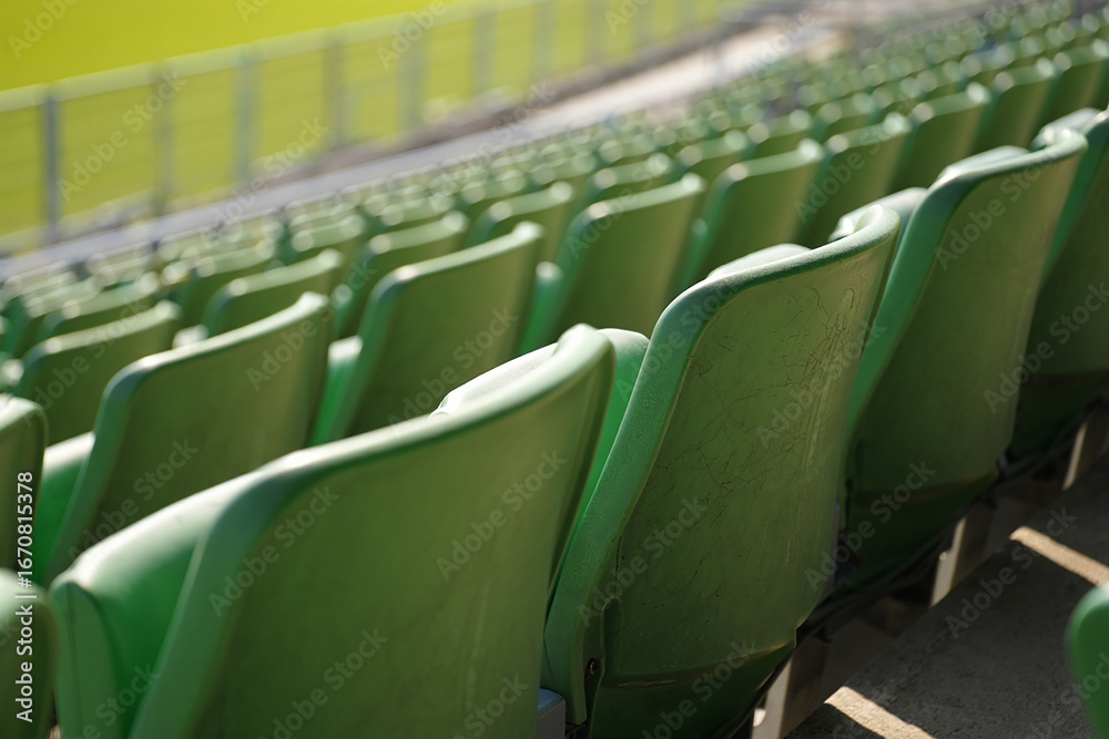 Fototapeta premium Empty green stadium seats in rows seating