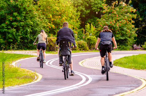 Wallpaper Mural Cyclists ride on the bike path in the city Park
 Torontodigital.ca