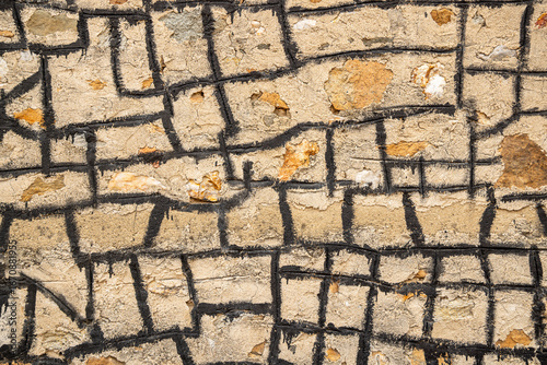 Masonary wall sealed with black tar.