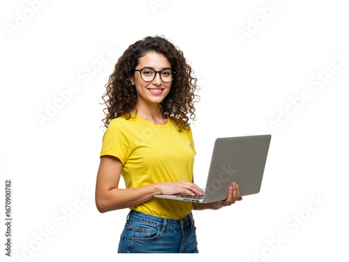 Smiling young woman with curly hair wearing glasses and a yellow t shirt holding a laptop isolated on transparent background