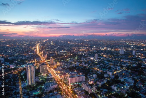 Wallpaper Mural Cityscape at dusk.  Aerial view of a sprawling metropolis at sunset.  Vibrant colors,  urban lights, and highways Torontodigital.ca