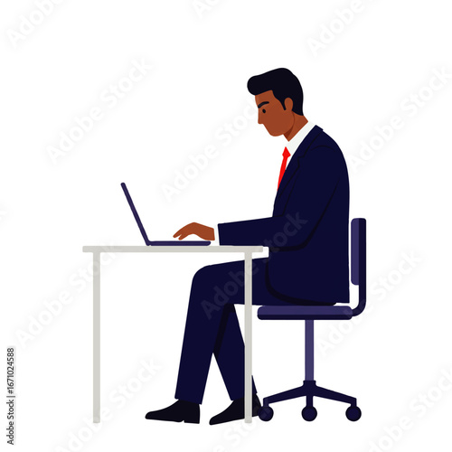 A dark-skinned businessman in a suit sits at a desk, typing on a laptop computer, focused on his work.