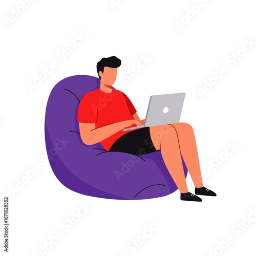 A man in a red shirt and black shorts sits in a purple beanbag chair, working on a laptop computer.
