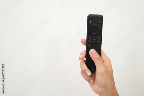 Wallpaper Mural woman's hand holding smart tv remote isolated on white background, copy space Torontodigital.ca