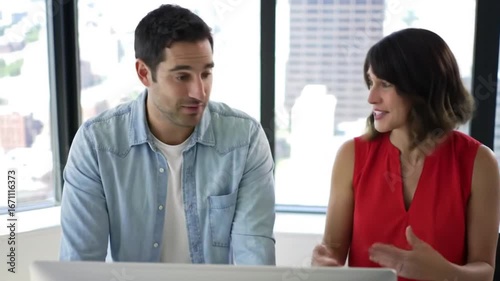 Business People Discussing Data on Computer Screen in Modern Office Space