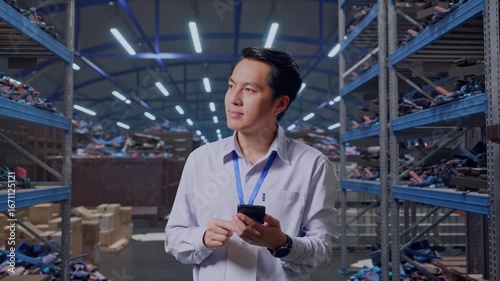 Wallpaper Mural Asian Male Professional Worker Standing With His Smartphone, Industrial Scrap Metal and Recycling Warehouse, He Observes By Looking Around Before He Come To Concentrating With His Smartphone Torontodigital.ca