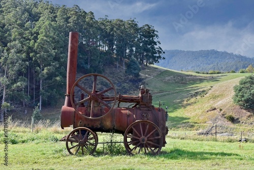 Old farm equipment steam engine machine to illustrate obsolete technology in agriculture.