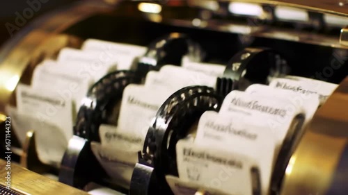 Close up of a vintage rolodex with business cards inside and brass exterior showing details clearly