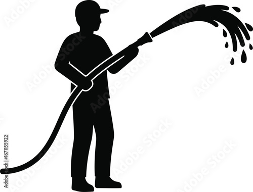 Silhouette of a man holding a hose spraying water