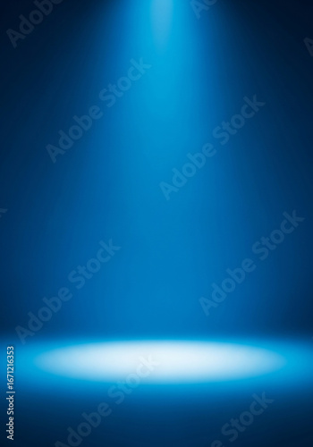 Bright blue spotlight illuminating an empty dark stage with a reflective floor