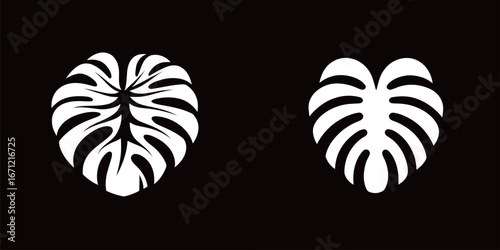 Wallpaper Mural Two stylized heart-shaped monster leaf silhouettes are displayed side by side on a black background, highlighting intricate leaf patterns and natural beauty. Torontodigital.ca