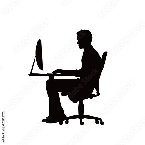 A person is seated at a desk, engaged in work on a computer. The setting is quiet, indicating concentration and productivity. The dim lighting suggests evening hours.