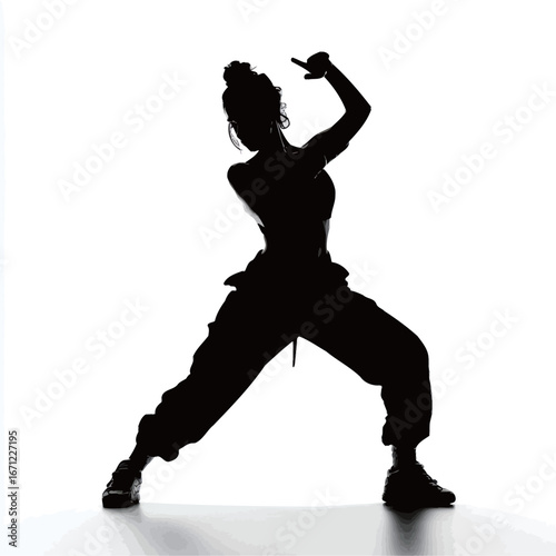 A dancer performs with confidence and energy, striking a powerful pose against a stark white background. The silhouette captures the grace and athleticism of the dance movement.