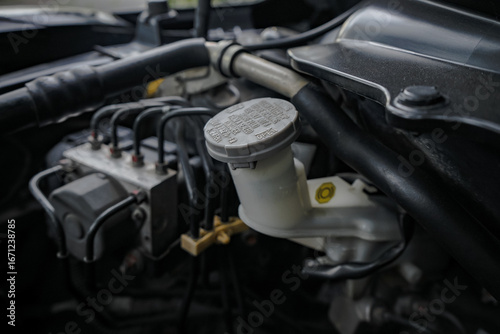 Close-up of the brake fluid tank inside the engine compartment. Checking the car's brake fluid level. Car repair and maintenance concept.