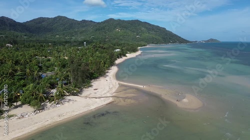 Wallpaper Mural Aerial drone footage of Baan Tai Beach on Koh Phangan, Surat Thani, Thailand, showing palm trees, tropical sandbanks, turquoise sea, green hills, and people swimming and relaxing in the water. Torontodigital.ca