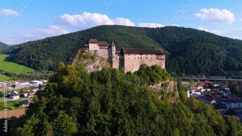 Wallpaper Mural Aerial view of the Orava castle at sunset in Slovakia. Medieval Oravsky Hrad castle on high and steep cliffs by the Orava River. Beautiful evening drone footage. Medieval fortress in golden light Torontodigital.ca