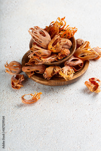 Obraz na plátne Indian spice mace or javitri in wooden plates on gray background with copyspace vertical shot