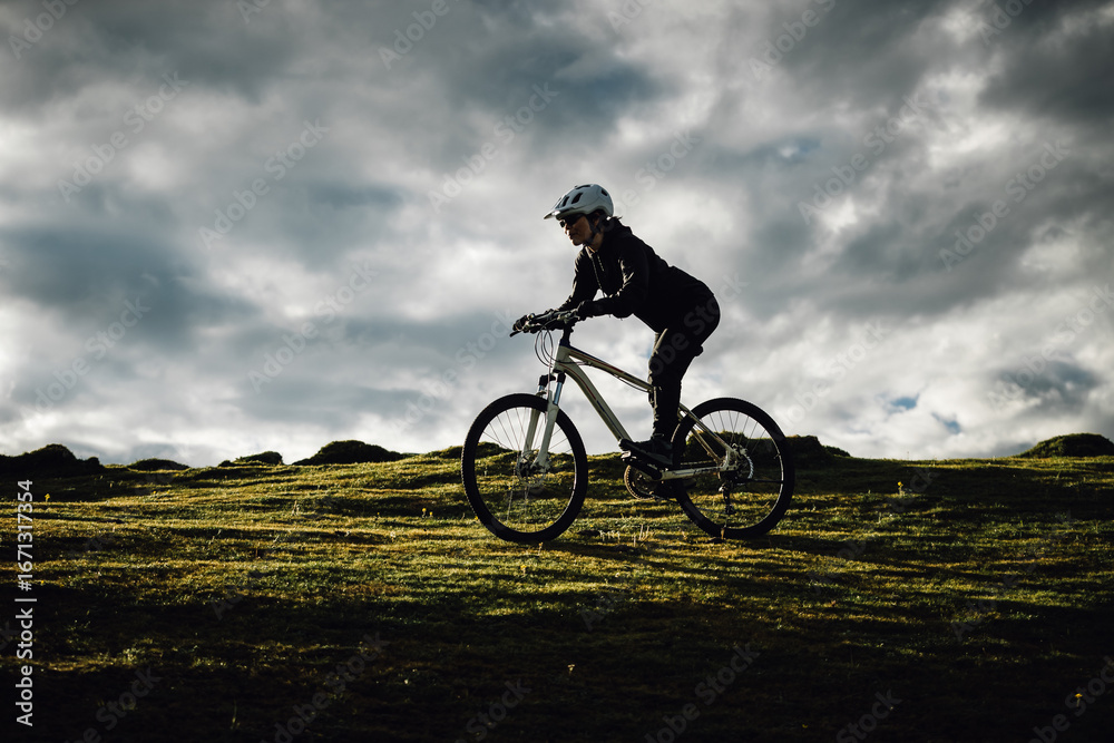 Fototapeta premium Riding mountain bike on grassland mountains