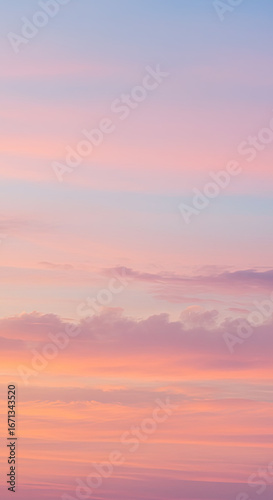 A breathtaking sunset sky, painted with soft pinks, oranges, and blues, displays a beautiful palette of colors and a serene mood.