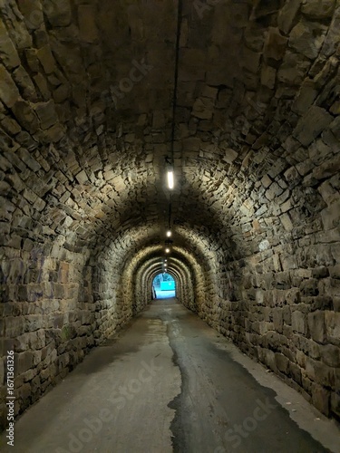 light at the end of the tunnel abstract concept that that a difficult or long-lasting period of hardship is finally coming to an end and that a better situation is approaching