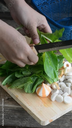 Preparing vegetables and herbs for tom yum soup in a countryside environment. Fresh ingredients and natural cooking atmosphere.