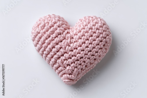 Pink crocheted heart on white background (1)