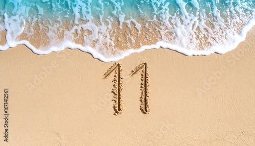 Number Eleven and Twelve Written in Sand on Beach with Ocean Waves in Background